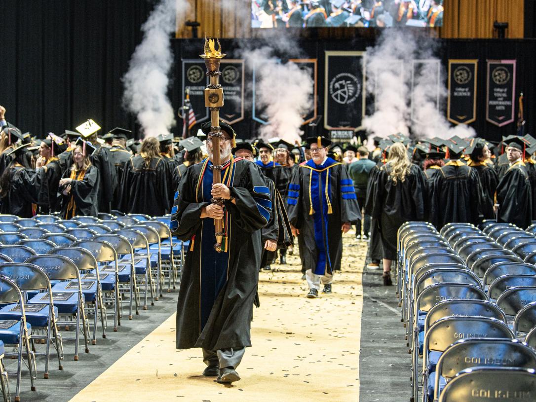 The ceremonial mace leaves the 2026 commencement ceremony