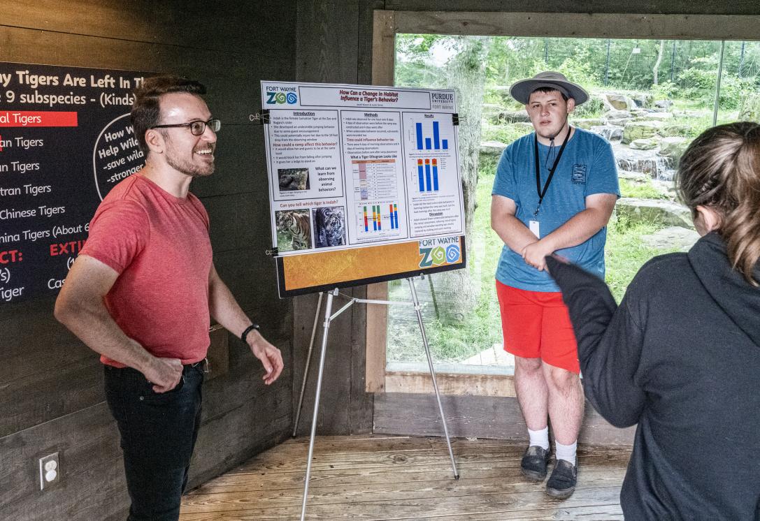 Student and instructor presenting presentation at the zoo.