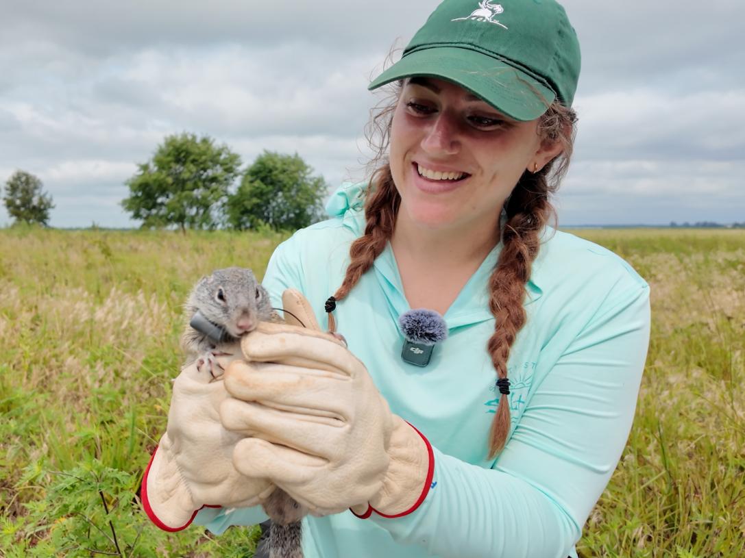 A student is holding a ground squirrel