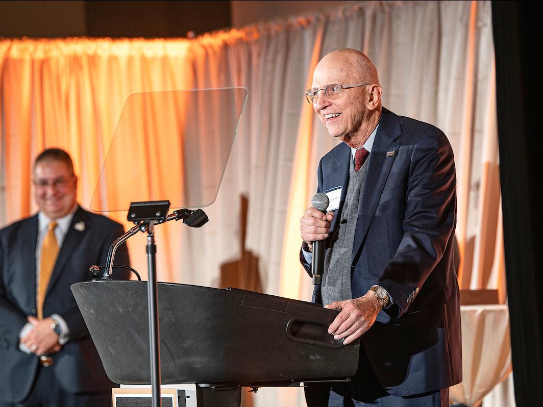 Howard Chapman is standing at a podium