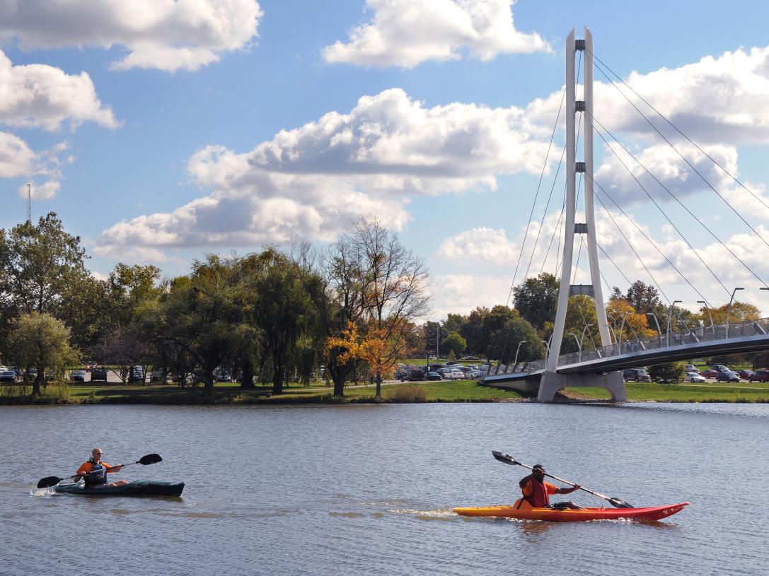 Kayaks on the St. Joseph River with the Ron Venderly Family Pedestrian bridge in the background.