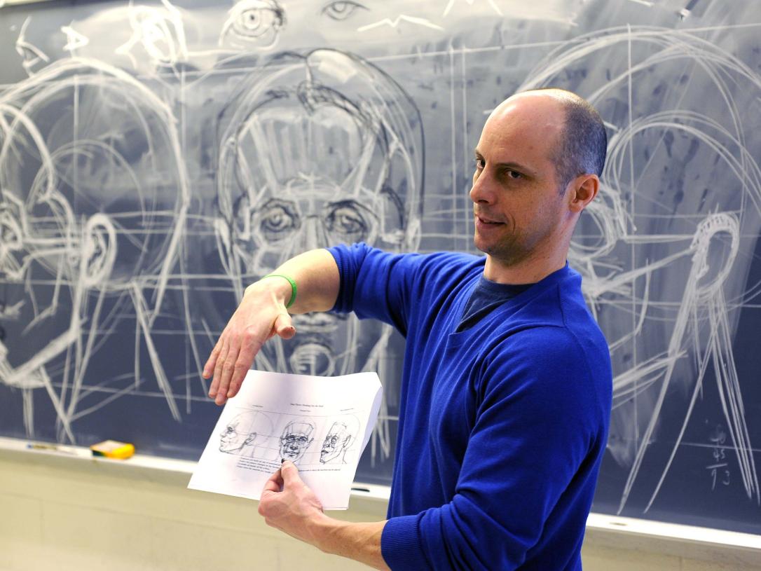 Figure drawing professor lecturing on faces and proportions in drawing.