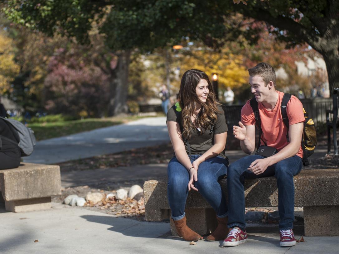 Students sitting on a bench.