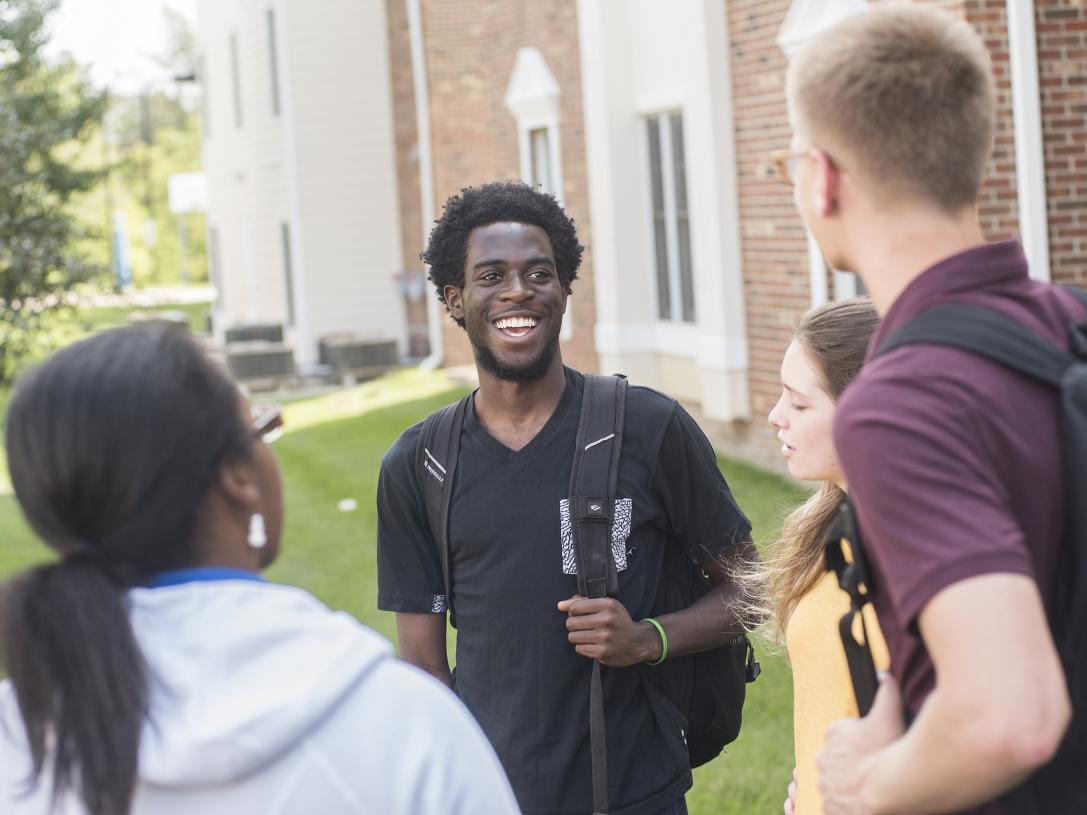 Students talking in a group.