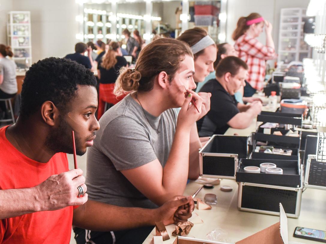 Diverse students put on makeup backstage at Williams theatre