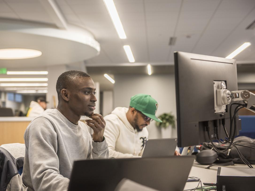 Student studying his class assignments on a computer.