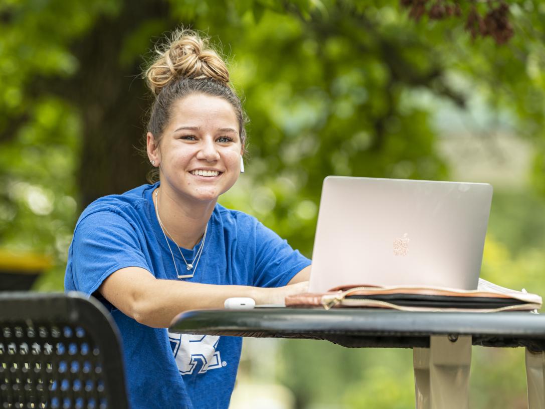 Student studying her class notes on her laptop.