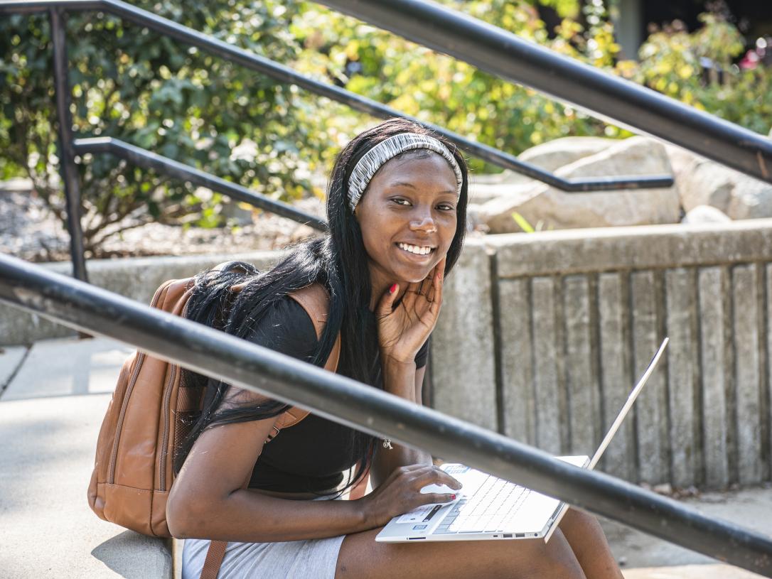 Student studying her class notes on her laptop.