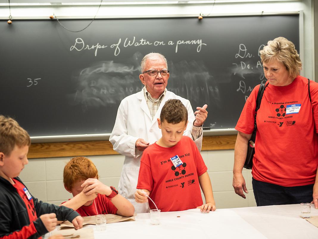 Photo of Professor Friedel working with students.
