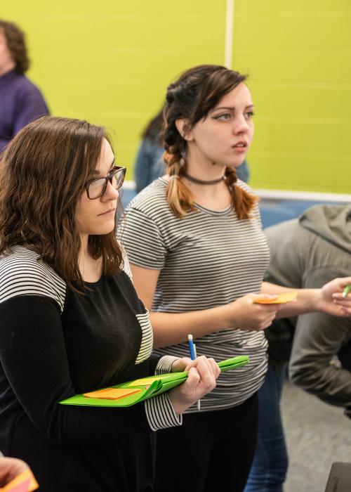 English students working on a project in a classroom.