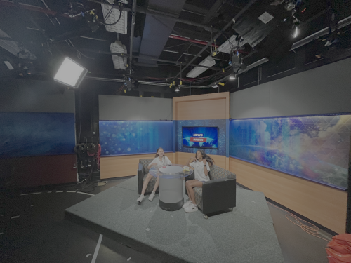 Two young students sit at a two-seat interview set in CollegeTV at Purdue Fort Wayne