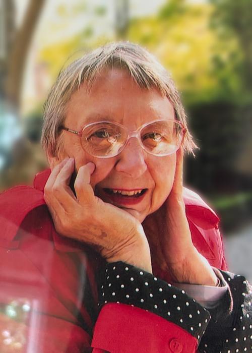 Portrait of Wilda Gene Marcus, a woman with glasses and short grey hair