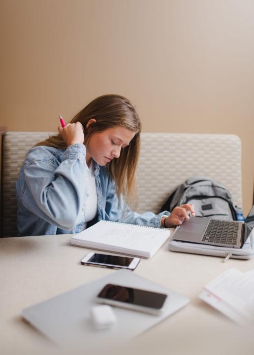 Female student reviewing notes from class.