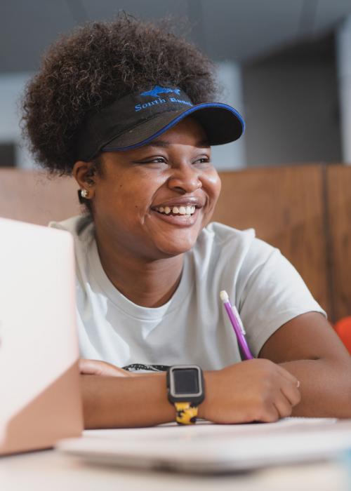 Female student reviewing notes from class.