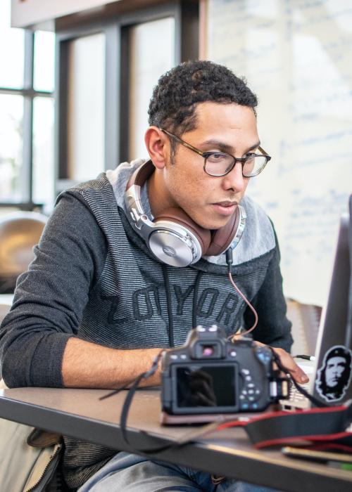Student with headphones studying.