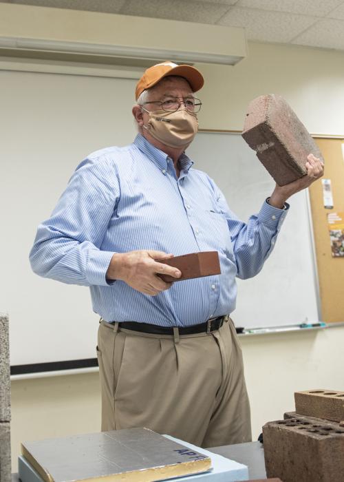 Professor lecturing in polytech classroom.