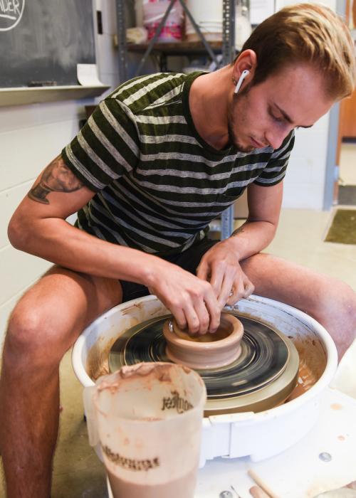 Student spinning a pot