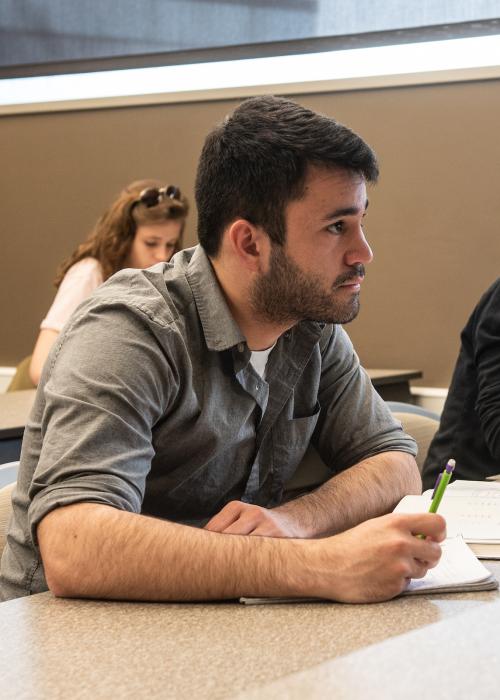 Students take notes in Arabic class.