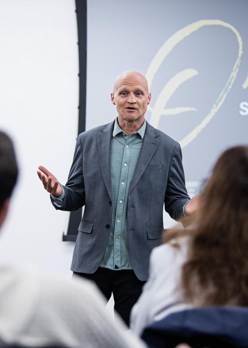 Scott Dikkers speaks to a group of students