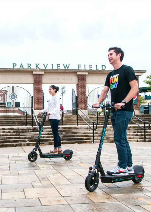 People riding on scooters