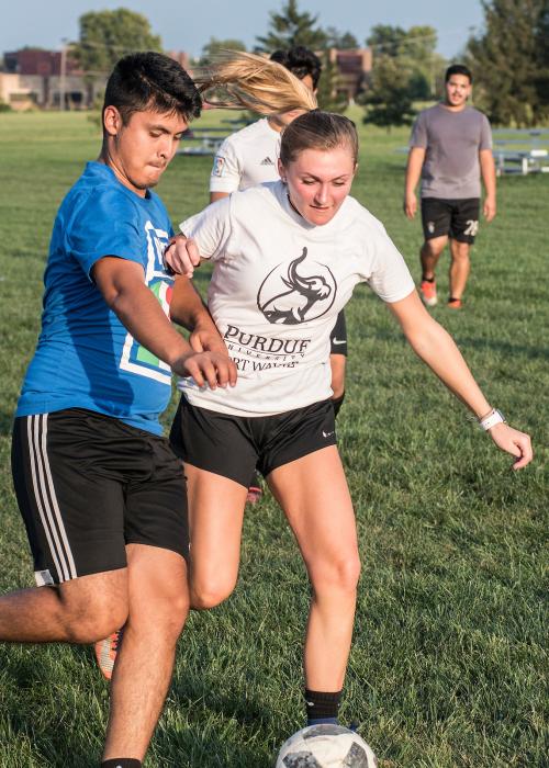 Students playing soccer