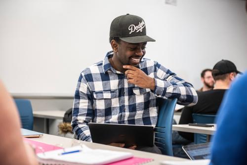 Student smiling in history class.