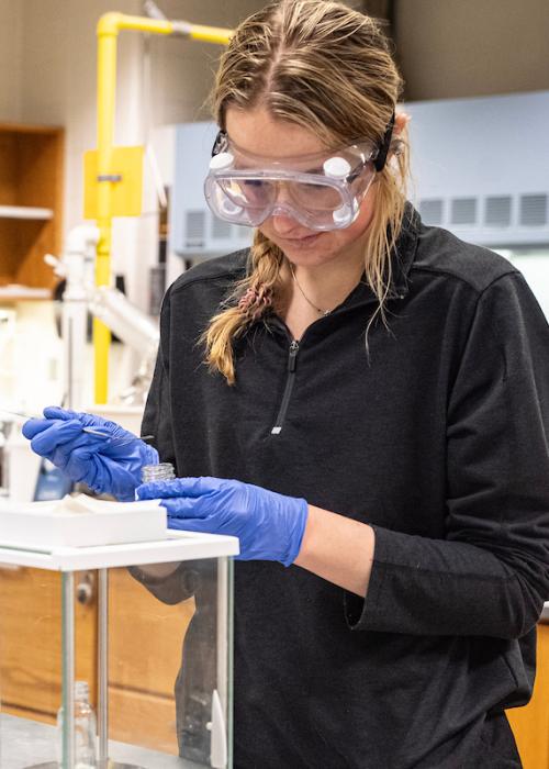 Students wearing safety equipment during a chemistry lab.