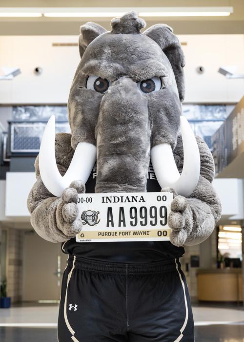 Don poses to show off a PFW license plate