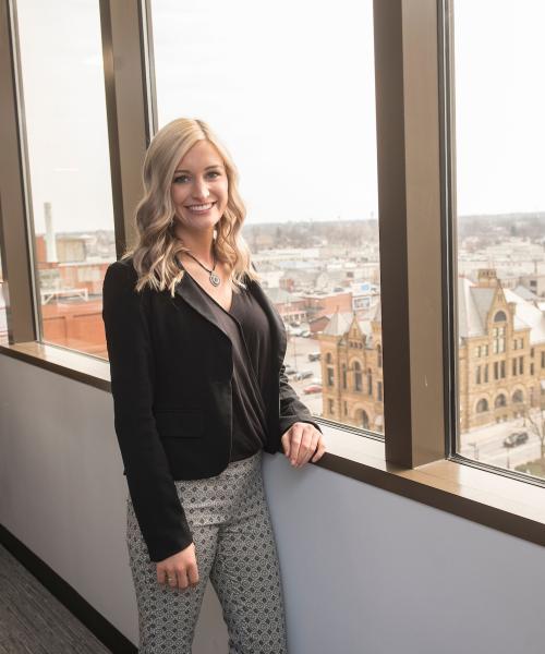 Female student posing in business setting.