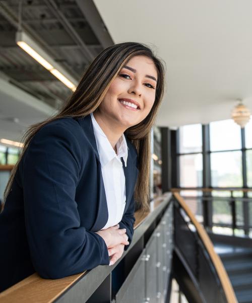 A female student smiling in the skybridge