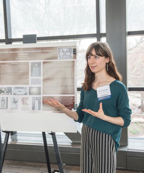 Student showing poster