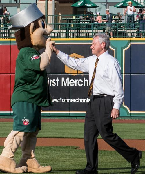 The chancellor high-fives Johnny at a Tincaps game.
