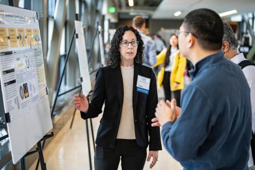 A mechanical engineering student presents a project during the Creative Symposium.