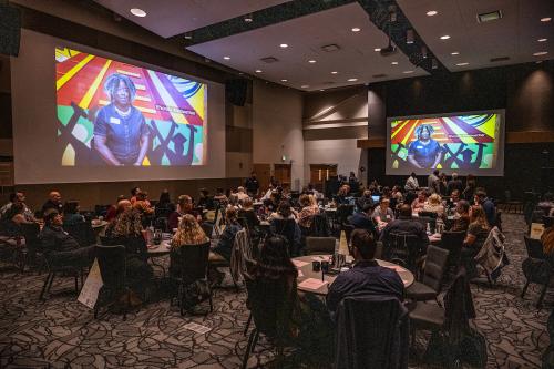 Participants in the October 30 meeting watching a video about the university.