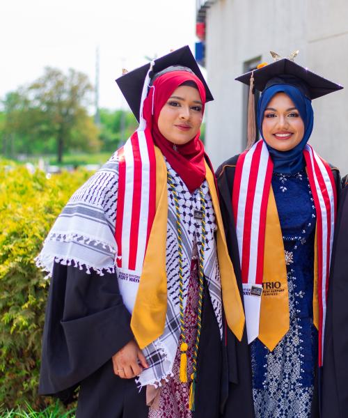 TRIO students pose in caps and gowns at commencement.