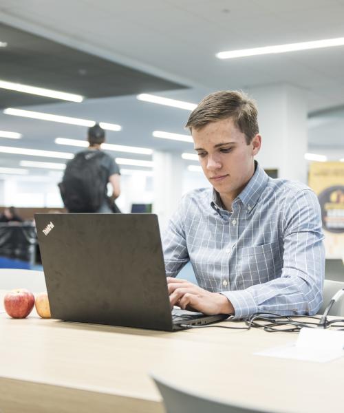 Student studying his class notes.