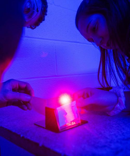 Physics Hologram Lab with students observing the demonstration.