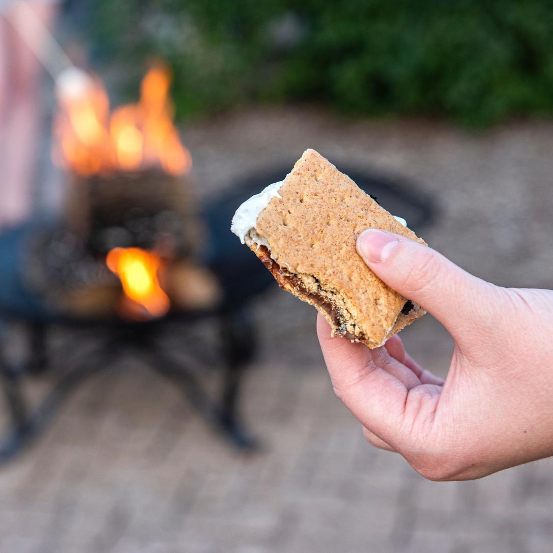 Hand holding a s'more.