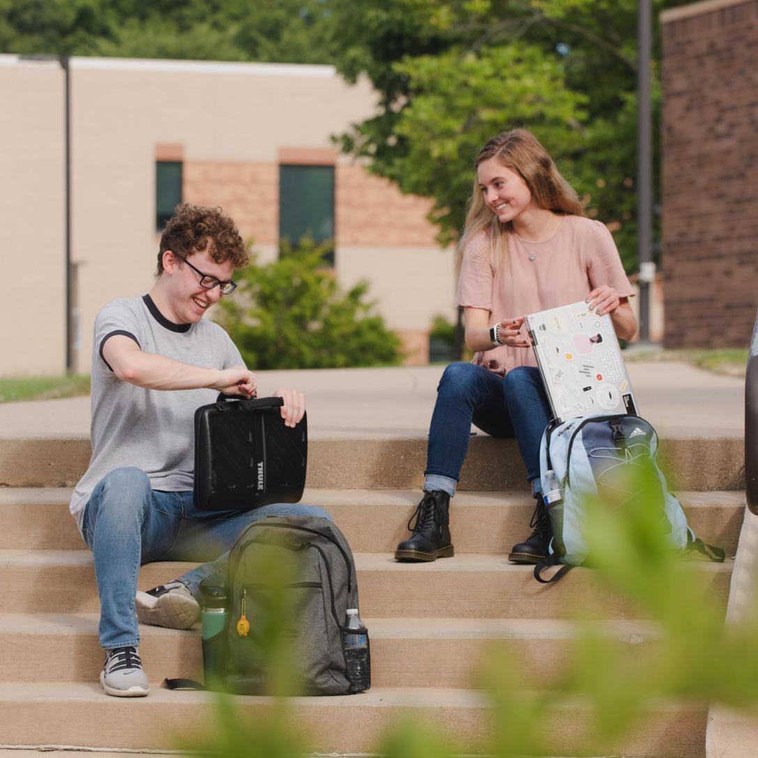 Students studying together outdoors.