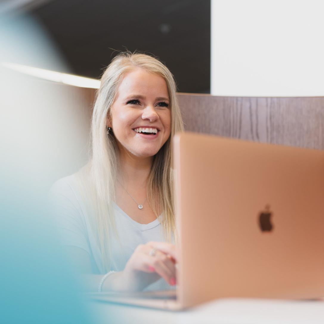 Female student reviewing notes from lecture on her laptop.