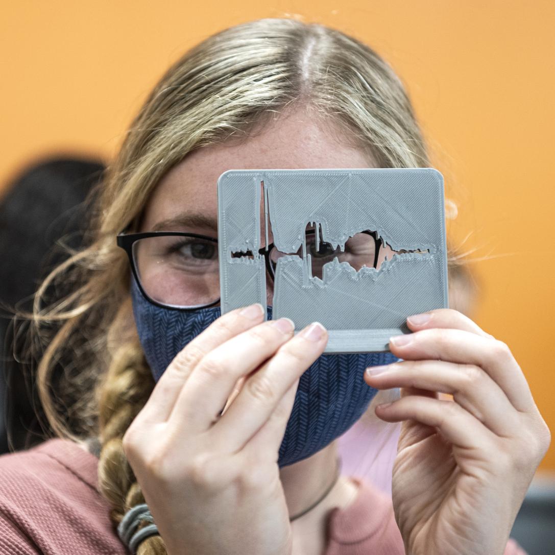 A CSD student holds a 3D printed model of a soundwave