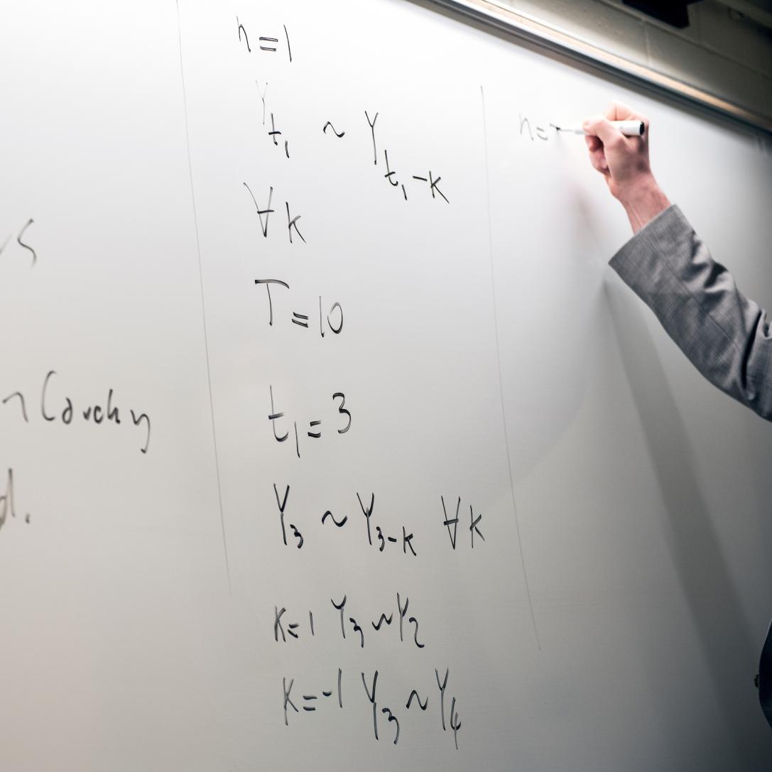 Whiteboard with math equations.