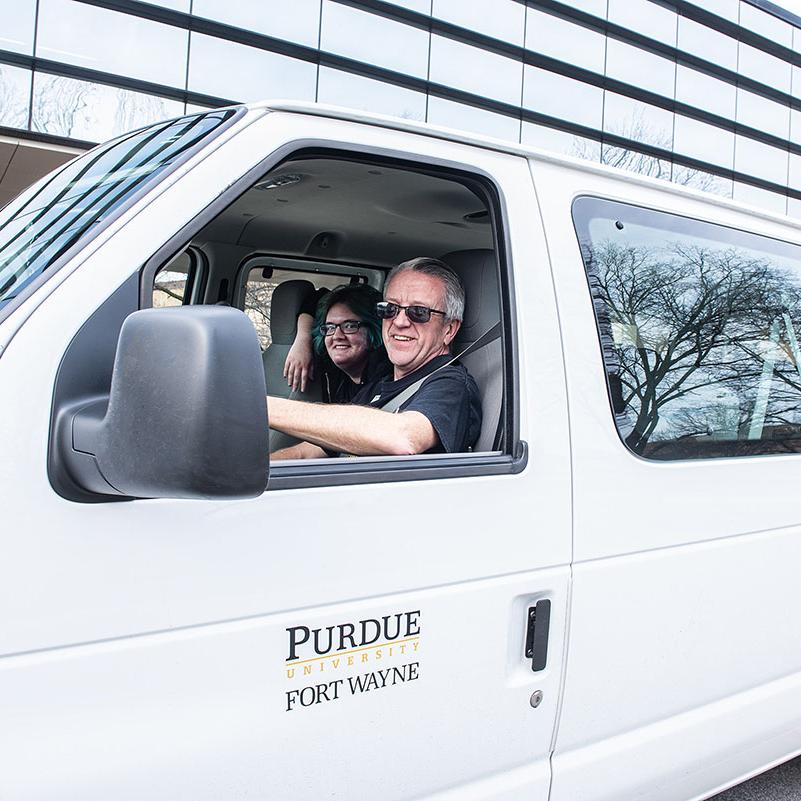 A driver is dropping off students on campus.