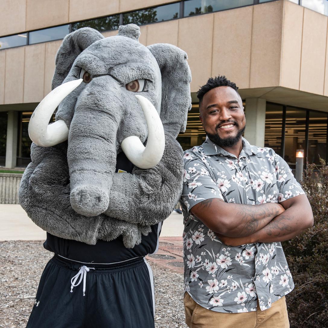 A Student Success Coach poses with Don.