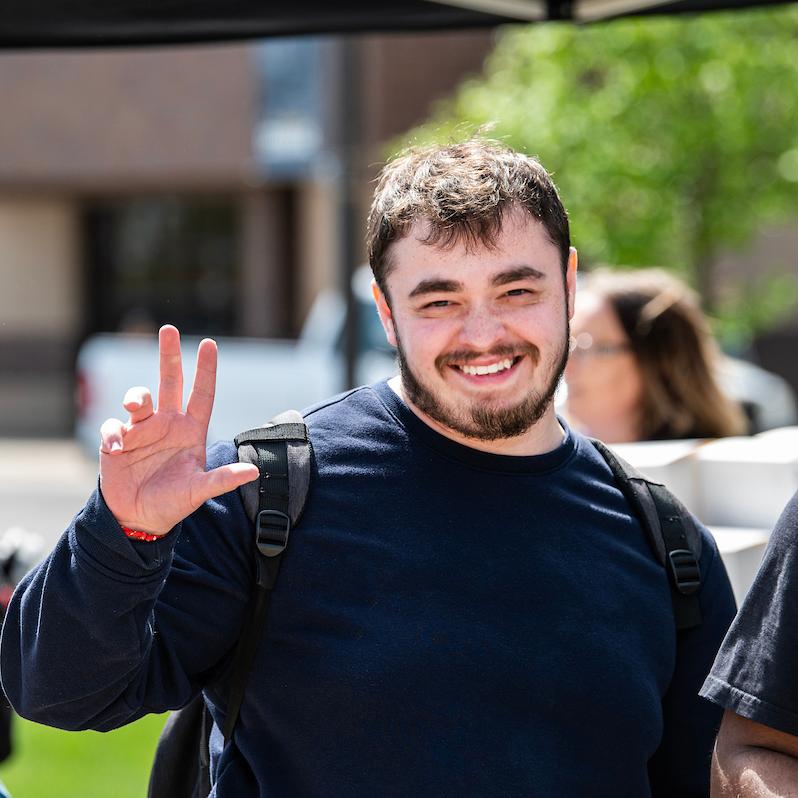 A PFW student waves to the camera.