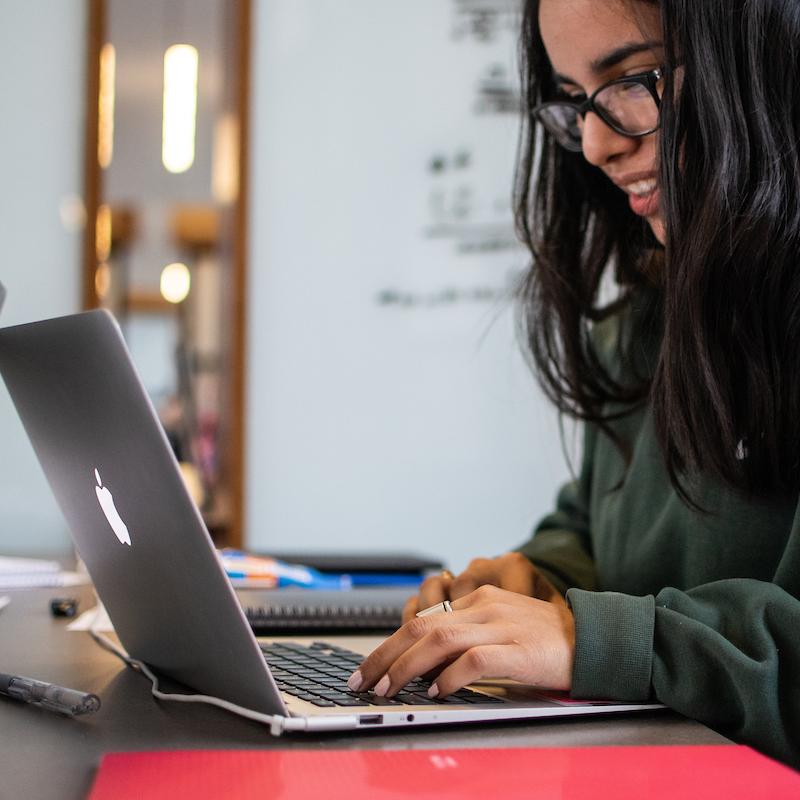 A student works on a laptop.