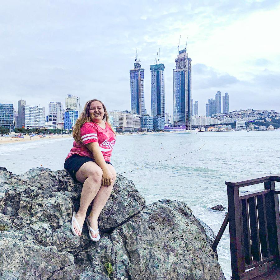Student sitting on a rock