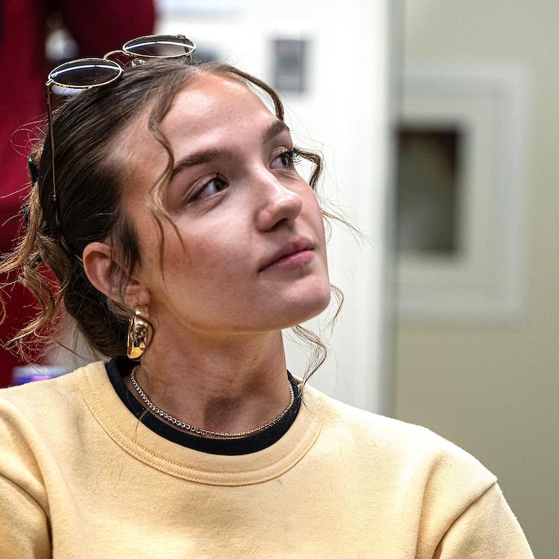 A student listens to a professor's lecture.