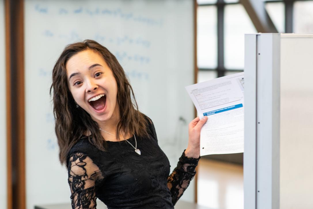 Student smiles for the camera while studying.