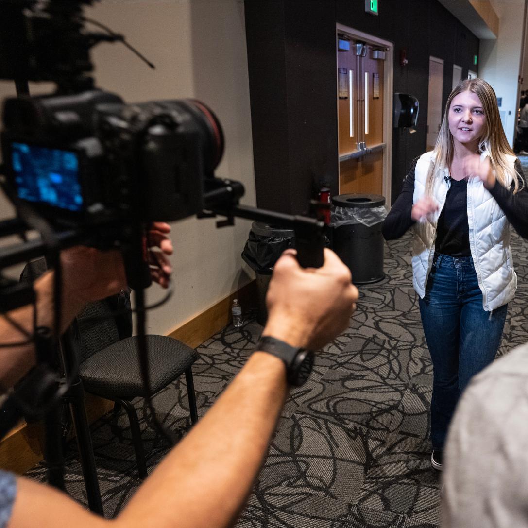 Multimedia team filming a video at a student event.